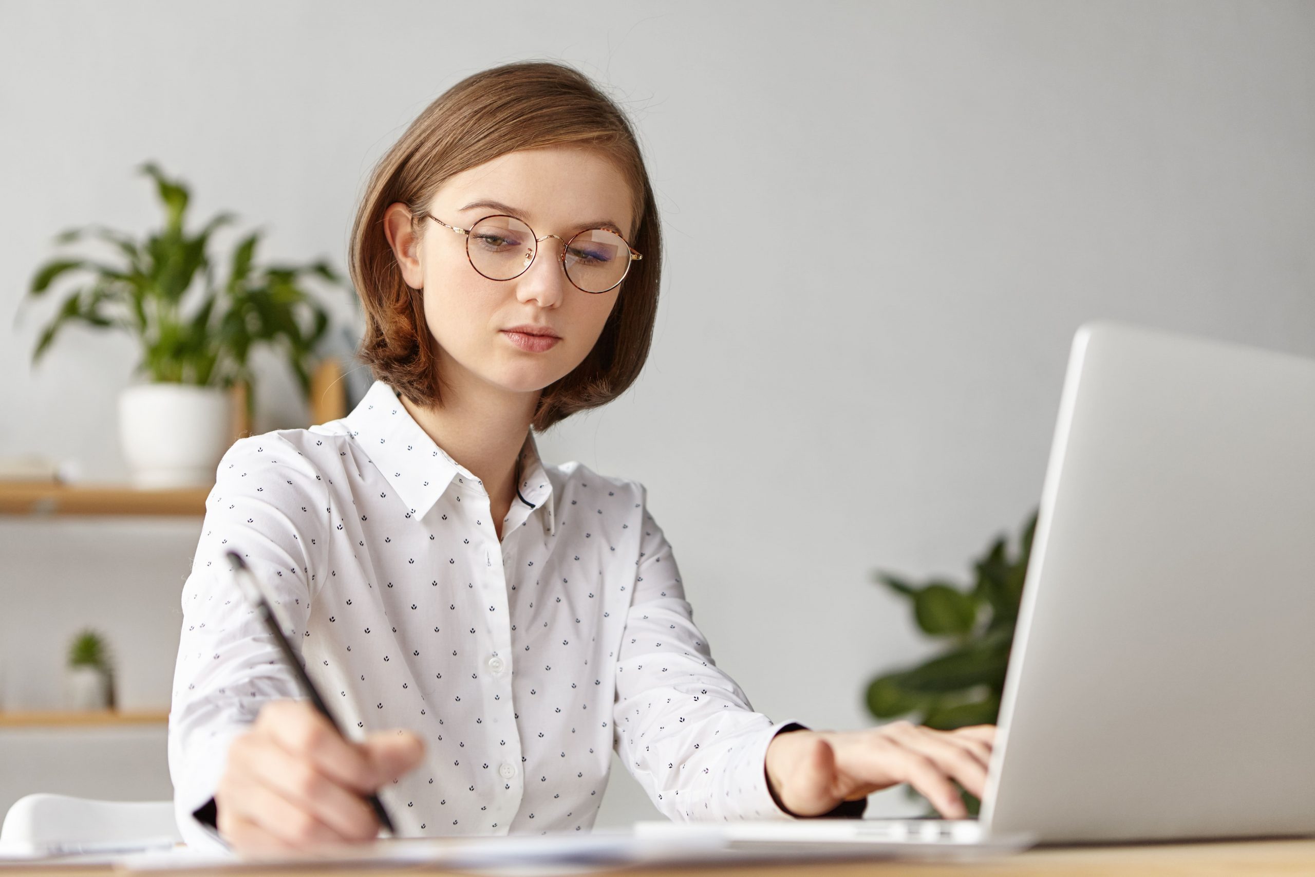 elegant-businesswoman-dressed-formally-sitting-with-laptop