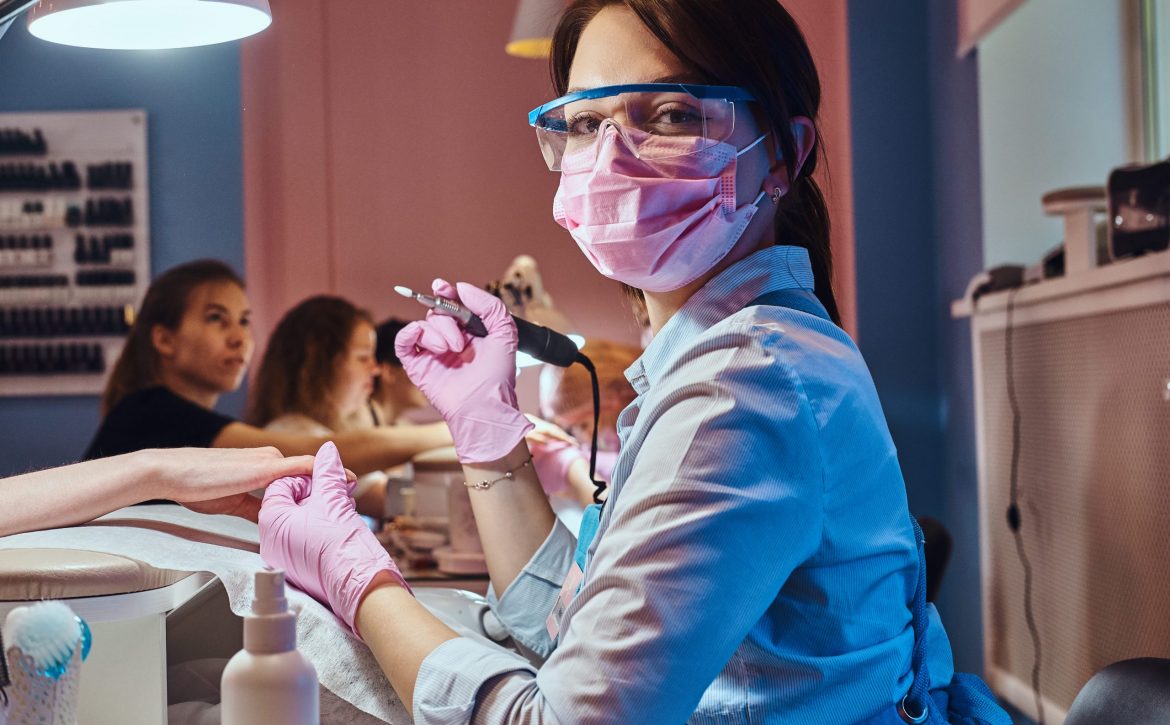 attractive-cheerful-manicurist-is-posing-photographer-while-doing-maicure-customer-1-scaled.jpg
