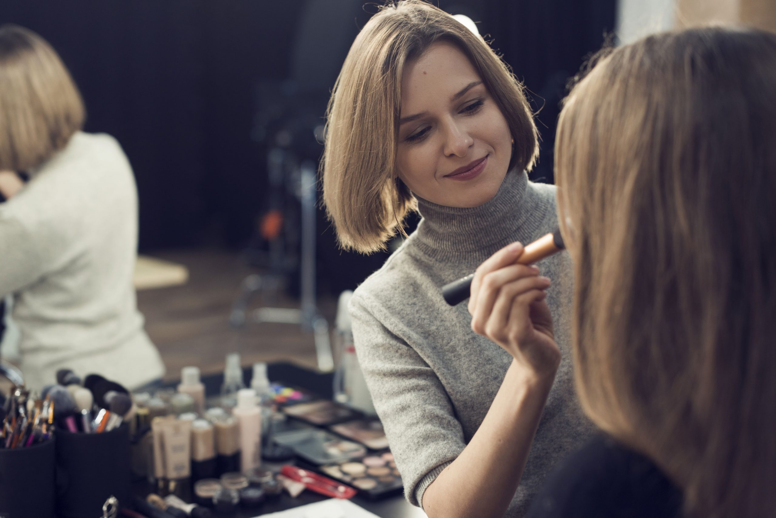 beautiful-stylist-applying-powder-model (2) (1)