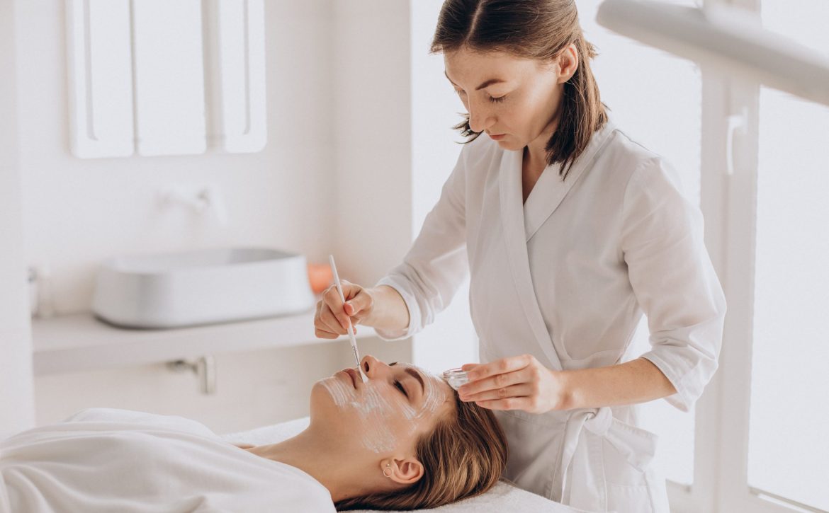 cosmetologist-doing-face-treatment-applying-face-mask