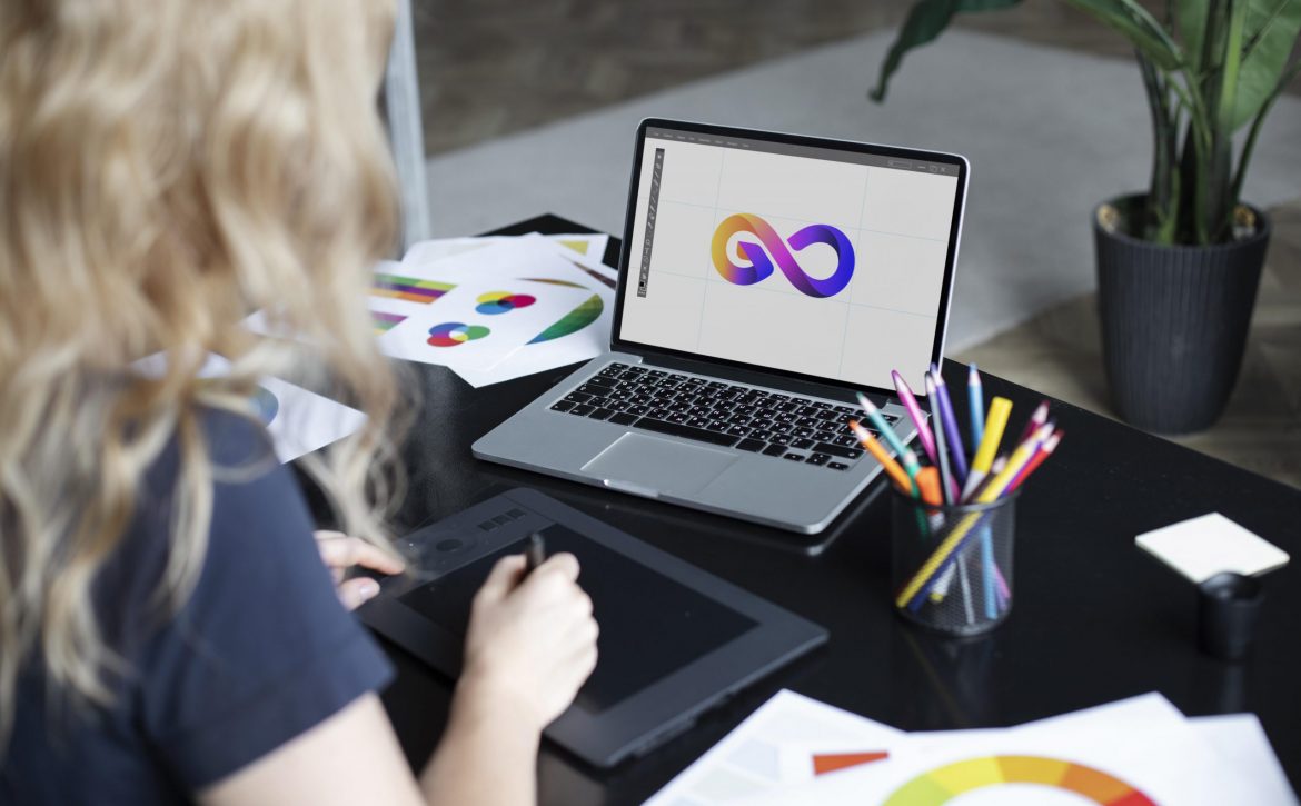 female-logo-designer-working-her-tablet-connected-laptop-scaled.jpg