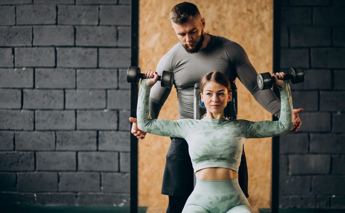 woman-doing-workout-gym-with-trainer (1)